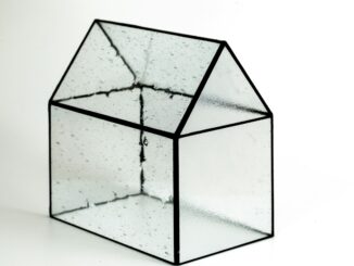 Transparent model of a building illustrating the trend towards open-source AI and the need for increased transparency around the development of artificial intelligence models to build trust, reduce risk, and improve security.